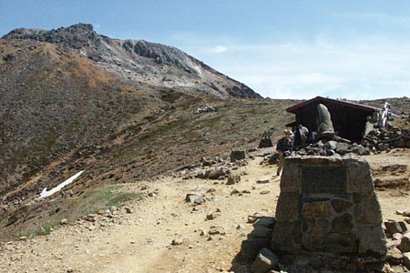 峰の茶屋跡避難小屋と茶臼岳の写真